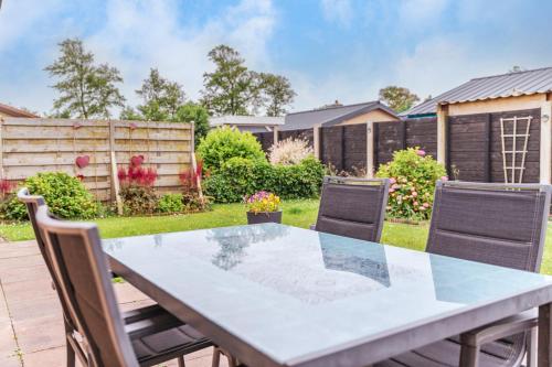 a table and chairs in a yard at Zeewaard 58 in Sint Maartensvlotbrug