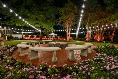 a park with benches and lights at night at Bama Bed and Breakfast - Wisteria Suite in Tuscaloosa