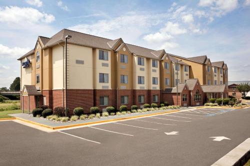 a rendering of a hotel with a parking lot at Microtel Inn & Suites by Wyndham Culpeper in Culpeper