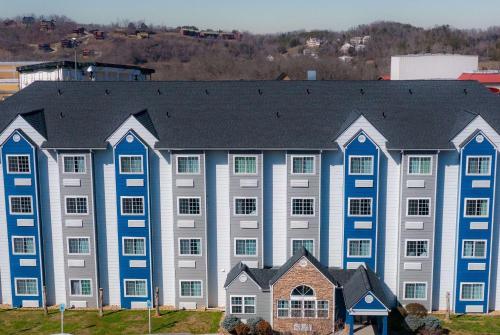 a large blue building with a black roof at Microtel Inn & Suites by Wyndham Pigeon Forge in Pigeon Forge