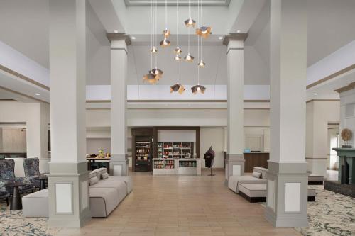 a lobby with columns and couches in a building at Hilton Garden Inn Hoffman Estates in Hoffman Estates