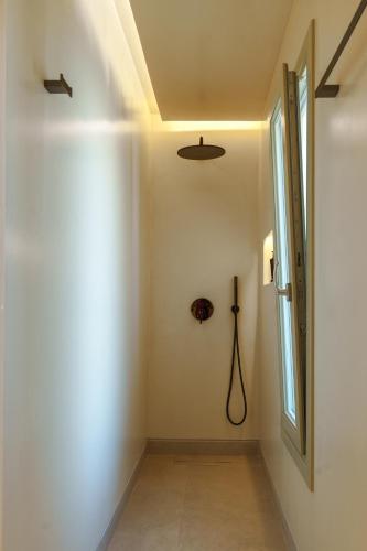 a hallway with a door and a window at Halo Santorini - Living Experience in Fira