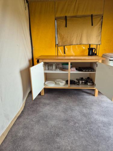 a room with a shelf in a tent at La Bedure in Luzy