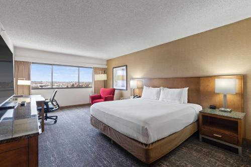 a hotel room with a large bed and a desk at DoubleTree by Hilton Spokane City Center in Spokane