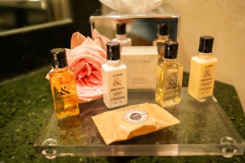 a group of four bottles of essential oils on a counter at Dukes' Arches Brugge - by Dukes' Hotel Collection in Bruges