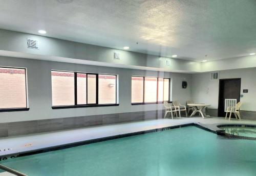a large swimming pool in a room with windows at Days Inn by Wyndham Kemah in Kemah