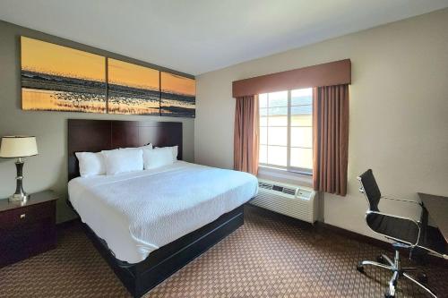 a hotel room with a large bed and a window at Days Inn by Wyndham Kemah in Kemah