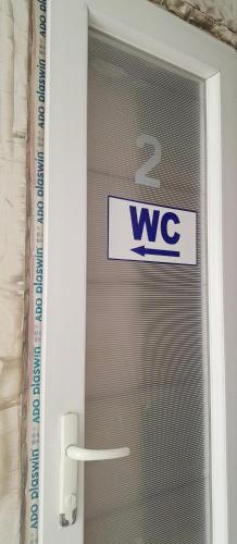 a sign on a glass door with aww sign on it at Guesthouse Qeti in Batumi
