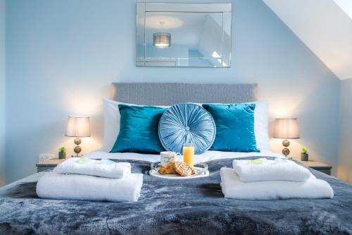 a blue bedroom with a bed with a tray of food on it at Progressive House 5 Bedrooms Inc Study with Sofabed, Garden, Smart TV in Every Bedroom FREE Parking in Peterborough