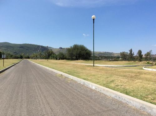 an empty road with a street light on the side at Hotel Y Parque Acuático La Caldera in Abasolo