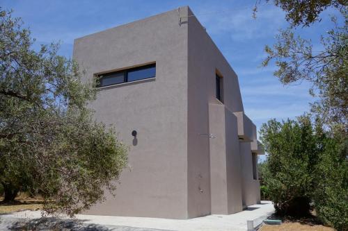 a building with a window on the side of it at Metóhi Vacation House in Gournes