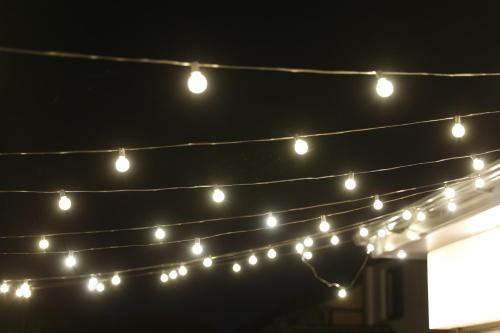 a group of christmas lights hanging from a string at The Orchard, 5 Star Luxury Accommodation in Newcastle