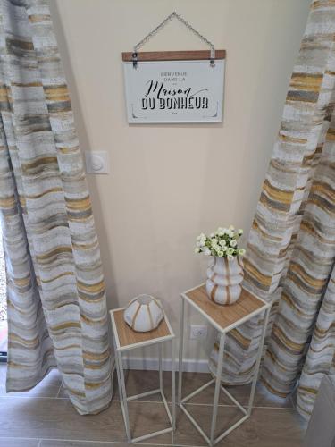 a room with curtains and a table with two chairs at Les suites d'Élise - Gîte Agathe in Grumesnil