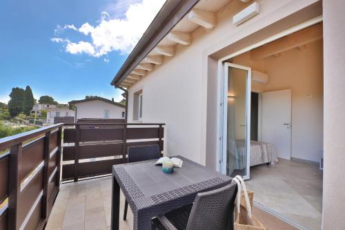 a patio with a table and chairs on a balcony at Camping Village Le Calanchiole in Capoliveri