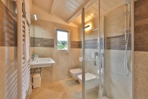 a bathroom with a shower and a toilet and a sink at Camping Village Le Calanchiole in Capoliveri