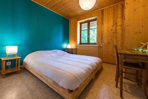 une chambre avec un grand lit et une fenêtre dans l'établissement 200m chalet for 14 people with a panoramic view of the valley, à Albiez-le-Jeune