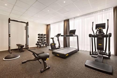 a gym with several exercise equipment in a room at Wyndham Garden Munich Messe in Munich