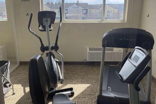 an exercise bike and a treadmill in a room at Wingate by Wyndham Pittsburgh New Stanton in New Stanton