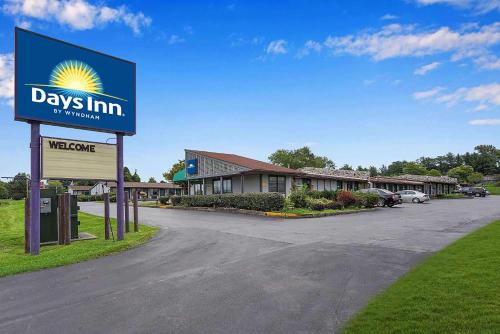 a days inn sign in front of a parking lot at Days-Inn by Wyndham Liverpool-Syracuse in Liverpool