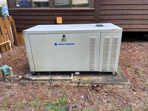 a generator sitting in the yard next to a house at Triangle Ranch in Masaryktown