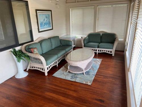 a living room with two couches and a table at Triangle Ranch in Masaryktown