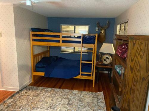 a bedroom with two bunk beds and a desk at Triangle Ranch in Masaryktown