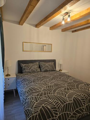 a bedroom with a bed and two night stands and two lamps at Apartments Rose 5 in Cres