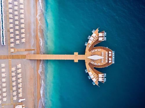an aerial view of a beach with buildings and the ocean at Mövenpick Resort Antalya Tekirova - Ultra All Inclusive in Tekirova