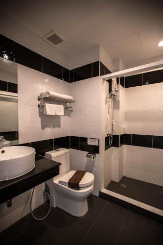 a bathroom with a toilet and a sink and a shower at CK Resort Pattaya in Nong Prue