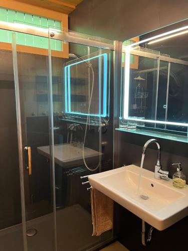 a bathroom with a glass shower and a sink at Chalet Ablon in Saalbach Hinterglemm