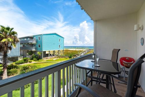 a balcony with a table and a view of the ocean at Villas on the Gulf unit J7 in Pensacola Beach