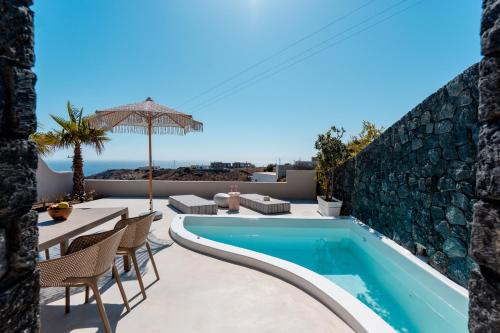 a villa with a swimming pool and a patio at Halo Santorini - Living Experience in Fira