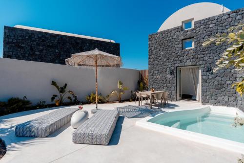 a villa with a swimming pool and a patio at Halo Santorini - Living Experience in Fira