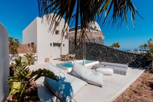 a villa with a swimming pool and a house at Halo Santorini - Living Experience in Fira