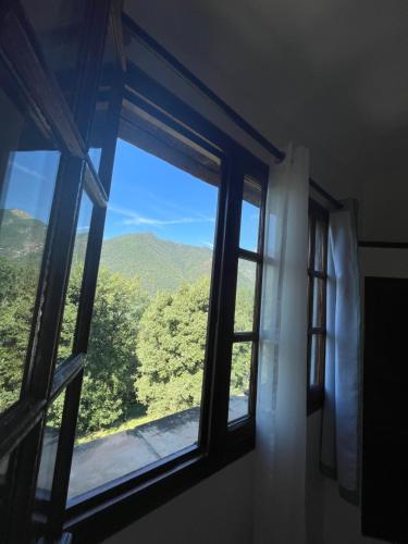 a window with a view of a mountain at Adorable gîte - Le figuier in La Bollène-Vésubie