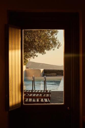 a window with a view of a body of water at 270 Oias View in Oia