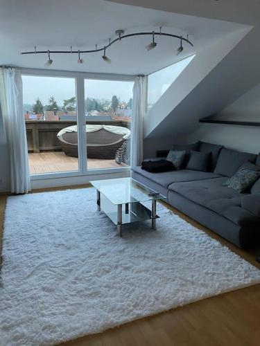 a living room with a couch and a table at Helles, modernes Appartement in Nuremberg