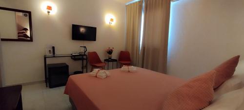 a room with a table and two red chairs at Hotel Alnacir in Faro