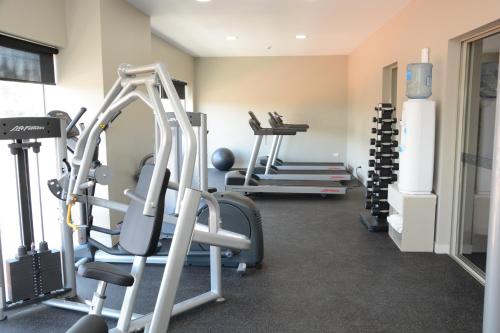 a gym with several tread machines in a room at Ratsun Nadi Airport Apartment Hotel in Nadi