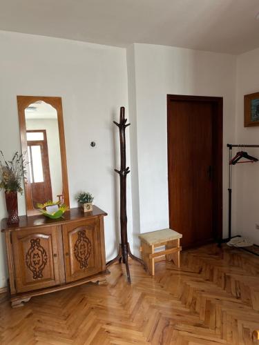 a room with a mirror and a wooden floor at Kecman in Drvar
