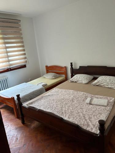 a bedroom with two beds and a window at Kecman in Drvar