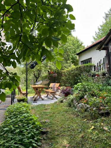 a garden with a picnic table and a bench at Kecman in Drvar