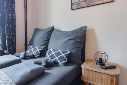 a blue couch with pillows in a room at TravelBase - Anklam in Anklam