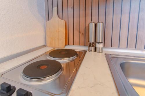 a kitchen with a stove with two burners on it at TravelBase - Anklam in Anklam