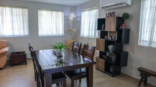 a living room with a dining room table with chairs at Ocean Villa Guam in Tamuning