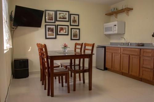 a kitchen with a table and chairs and a microwave at Ocean Villa Guam in Tamuning