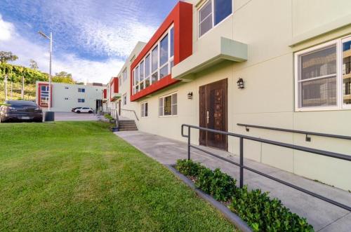 a building with a car parked in a parking lot at Tumon Isa 16 Condo in Tamuning