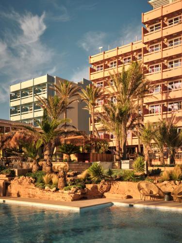 a resort with a swimming pool in front of a building at Bikini Island & Mountain Hotel Es Trenc -Adults only- in Colonia Sant Jordi
