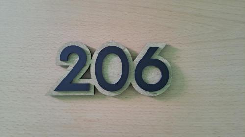 a sign on a wall with the number at Hotel Victorino in Silleda