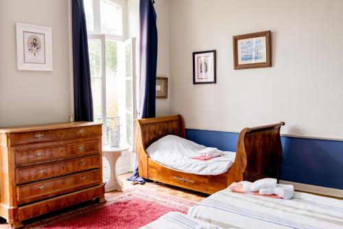 a bedroom with two beds and a dresser at Séminaire,famille,amis,15 couchages, proche plages in Saint-Gervais